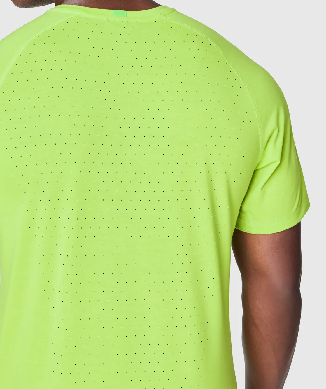 FWD — lime training tee, laser-perforated back and raglan seam